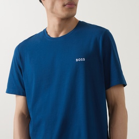 Model wearing blue BOSS crew neck T-shirt with small embroidered chest logo, cropped torso view