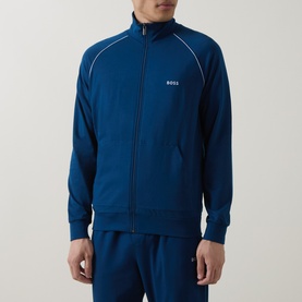 Model wearing Hugo Boss turquoise zip-through lounge jacket with white piping detail and small logo, styled with matching joggers.