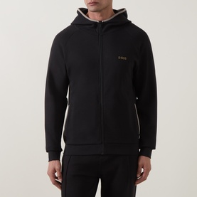 Hugo Boss black zip-through hoodie with gold logo, contrast beige hood lining and ribbed cuffs, styled with black joggers.
