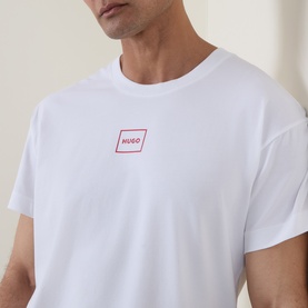 Model wearing Hugo Laze Logo Lounge T-Shirt in white, featuring a red box logo print on chest, crew neck and short sleeves.