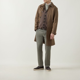 Model wearing John Smedley Rockford Shawl Cardigan in Light Brown, styled with a tan overcoat and sage green trousers.