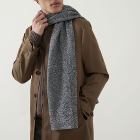 Model with John Smedley Knit Oblong Scarf in grey marl cashmere-wool blend, styled over a tan overcoat