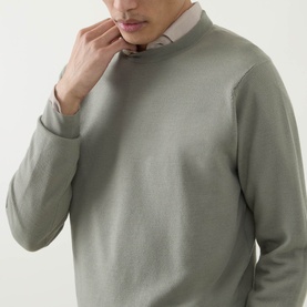 Model wearing John Smedley 15.Singular Knit Sweater in Thistle Drew, crew neck merino wool jumper with ribbed trims, styled over a shirt.