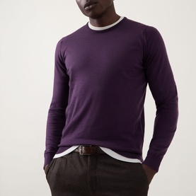 Model wearing John Smedley Lundy Extra Fine Knit Sweater in Velvet Plum, crew neck, styled with white tee and dark trousers