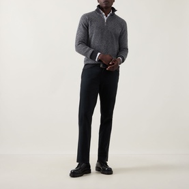 Model wearing John Smedley Inghram Textured Half-Zip Sweater in charcoal, styled with black trousers and black leather shoes.