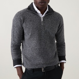 Model wearing John Smedley Inghram Textured Half-Zip Sweater in charcoal, styled with a white shirt and dark trousers.