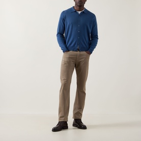 Model wearing John Smedley Tibor Fine Knit Polo Cardigan in Teal Firth, styled with tan trousers and dark loafers