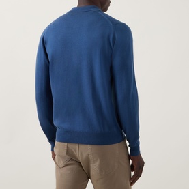 Model wearing John Smedley Tibor Fine Knit Polo Cardigan in Teal Firth, back view, styled with beige trousers