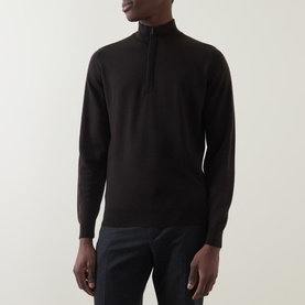 Model wearing John Smedley Tapton Extra Fine Knit Half-Zip Sweater in dark brown, styled with navy trousers.