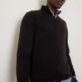 Model wearing John Smedley Tapton Extra Fine Knit Half-Zip Sweater in dark brown, styled over a light blue collared shirt.