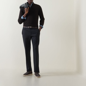 Model wearing John Smedley Tapton Extra Fine Knit Half-Zip Sweater in dark brown, styled with navy trousers, light blue shirt and grey scarf.