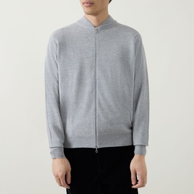 Model wearing John Smedley 16.Singular Extra Fine Knit Jacket in light grey with zip-through fastening, ribbed trims, styled with black trousers.