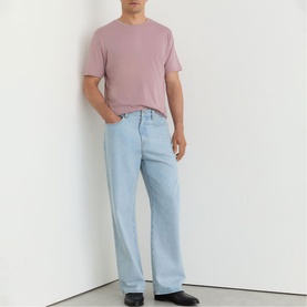 Model wearing Reiss dusty rose crew neck T-shirt with light wash wide-leg jeans
