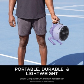 Model with Shark FlexBreeze HydroGo Misting Fan in Lavender, held at side on outdoor court, purple portable design