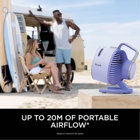 Shark FlexBreeze HydroGo Misting Fan in purple, shown outdoors on a surface with a beach lifestyle background and text noting 20m airflow