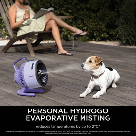Shark FlexBreeze HydroGo Misting Fan in purple, placed on decking outdoors near a small dog, with mist visible