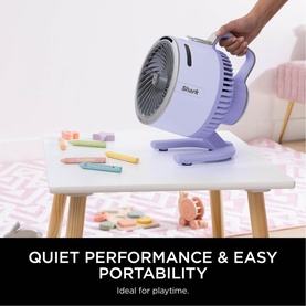 Shark FlexBreeze HydroGo Misting Fan in purple, carried by handle, styled in a child's playroom with toys and pink rug