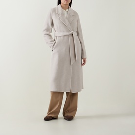 Model wearing Hugo Boss Open White wool-blend belted wrap coat, styled with wide-leg camel trousers and brown shoes.