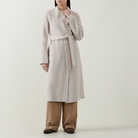 Model wearing Hugo Boss Open White wool-blend belted wrap coat, styled with wide-leg tan trousers.