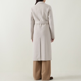 Model wearing Hugo Boss Open White wool-blend belted coat, shown from behind, styled with wide-leg camel trousers