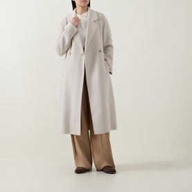 Model wearing Hugo Boss Open White wool-blend longline coat, styled with wide-leg camel trousers and brown loafers.