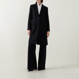 Model wearing Hugo Boss black wool coat, single-breasted with notch lapel, styled with wide-leg black trousers and white shirt.