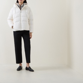 Model wearing Hugo Boss Open White puffer coat with hood, styled with black cropped trousers and black loafers