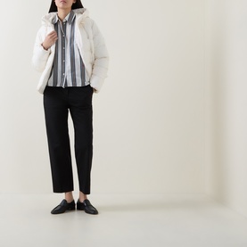 Model wearing Hugo Boss Open White quilted polyester puffer jacket, styled with striped shirt, black trousers and loafers.