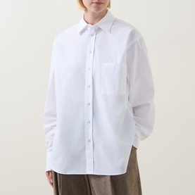 Model wearing Hugo Boss Saturday Patch Pocket Oversized Shirt in white, long sleeves, pointed collar, patch chest pocket, with khaki trousers