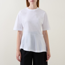 Model wearing Hugo Boss white cotton T-shirt with peplum hem and crew neck, styled with black trousers