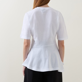 Model wearing Hugo Boss white cotton T-shirt, back view, featuring peplum hem and short sleeves, styled with black trousers.