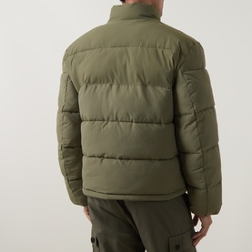 Model wearing Hugo Casual Jacket in Open Green, rear view, quilted puffer style with stand collar, styled with matching green cargo trousers.