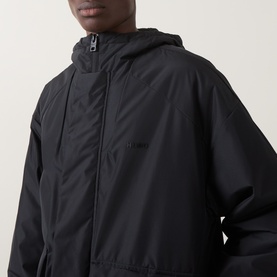 Model wearing Hugo casual jacket in black, featuring zip-up hood, zip chest pocket and subtle logo print to chest.