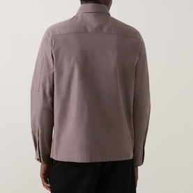 Model wearing mauve long-sleeve overshirt, rear view, styled with black trousers