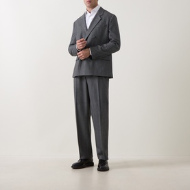 Model wearing Hugo dark grey suit jacket with matching trousers and white shirt, styled with black leather shoes.