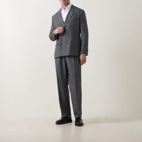 Model wearing Hugo dark grey suit jacket with matching trousers and white shirt, styled with black leather loafers.