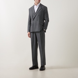 Model wearing Hugo dark grey suit trousers with matching double-breasted jacket, white shirt, and black loafers.