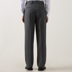 Model wearing Hugo dark grey suit trousers, rear view, styled with a white dress shirt and black shoes.