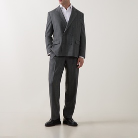 Model wearing Hugo dark grey suit trousers with matching double-breasted blazer, white shirt, and black leather shoes.