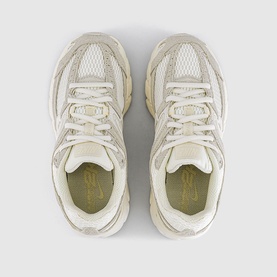 Nike trainer in Sail Pale Ivory Phantom colourway, overhead flat-lay view showing mesh and synthetic upper with cream chunky sole.