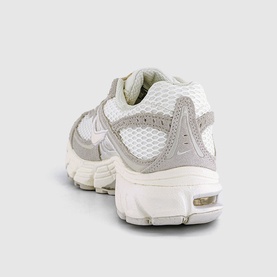 Nike trainer in Sail Pale Ivory Phantom, white mesh upper with grey suede overlays, visible Air unit, cream rubber sole, rear three-quarter view.