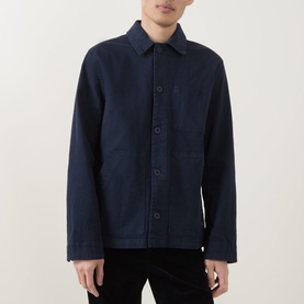 Model wearing Paul Smith navy cotton casual jacket with spread collar, button front, and patch pockets, styled with black trousers