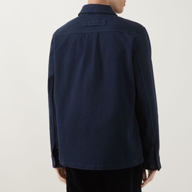Model wearing Paul Smith navy cotton casual jacket, rear view showing back yoke detail and shirt-style collar.