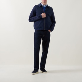 Model wearing Paul Smith Navy Casual Jacket, styled with dark jeans, blue shirt and cream trainers