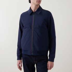 Model wearing Paul Smith Navy Casual Jacket with zip front, shirt collar, and ribbed cuffs, styled with dark denim jeans.