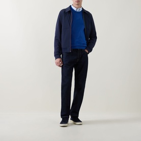 Model wearing Paul Smith Navy Casual Jacket, styled with a blue crew-neck jumper, light blue shirt, dark trousers and navy trainers.