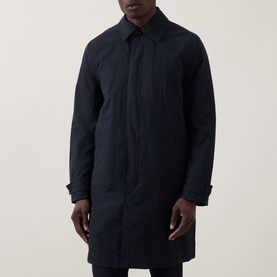Model wearing Paul Smith Navy Showerproof Car Coat with concealed button front, point collar, and tabbed cuffs, longline fit