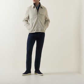 Model wearing Paul Smith Technical Harrington Jacket in brown with navy trousers and navy trainers