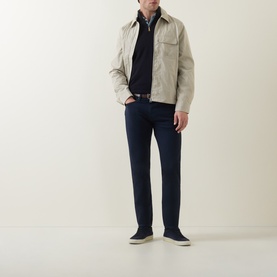 Model wearing Paul Smith Technical Harrington Jacket in brown with navy trousers, black polo and navy trainers.
