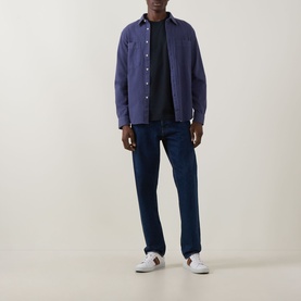 Model wearing Paul Smith navy casual shirt, styled with black T-shirt, dark jeans and white trainers